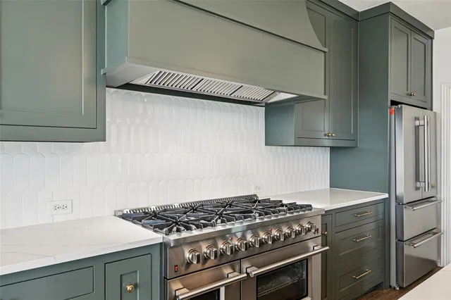 a view of a kitchen with wooden floor and electronic appliances