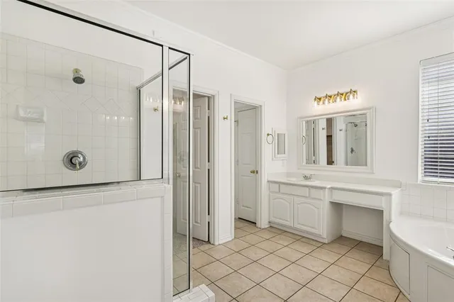 an empty room with wooden floor and a ceiling fan
