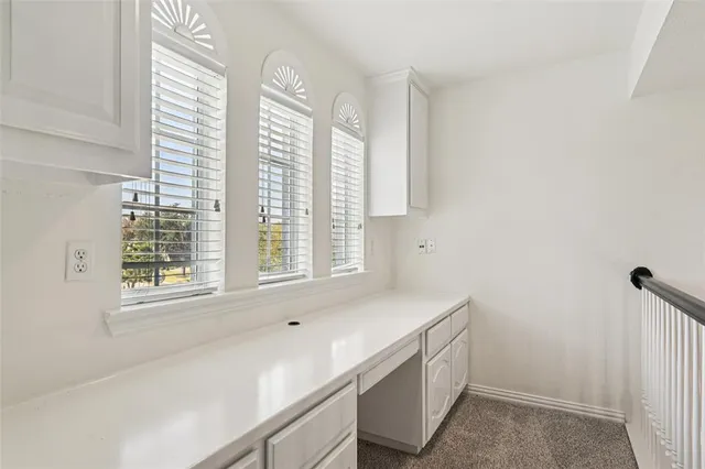 an empty room with a empty space and windows