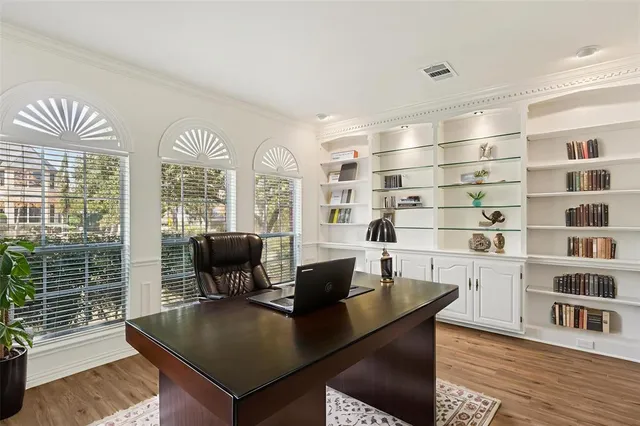 a view of a workspace with furniture and a potted plant