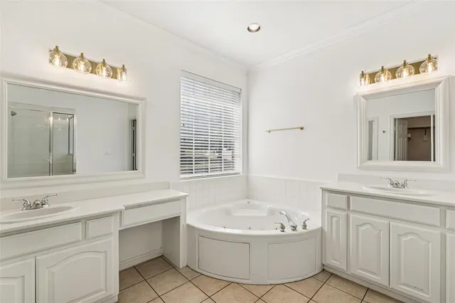 a bathroom with a bathtub a sink a mirror a vanity and window