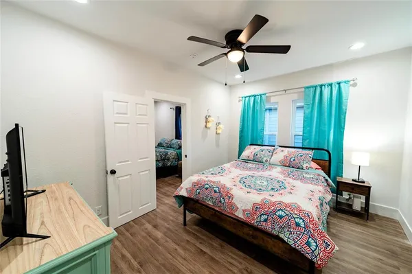 a bedroom with a bed and a flat screen tv