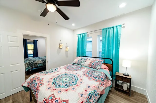 a bedroom with a bed and a chandelier