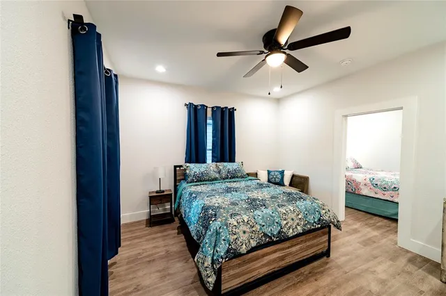 a bedroom with a bed and a ceiling fan