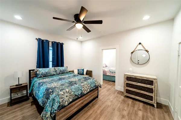 a bedroom with a bed and wooden floor