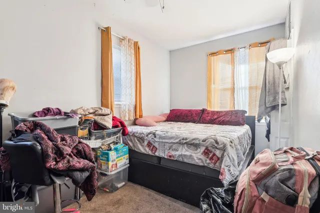 a bedroom with a bed a balcony and a bed