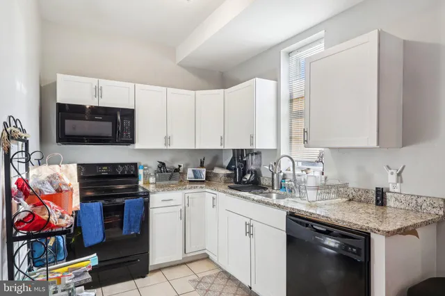a kitchen with stainless steel appliances granite countertop a stove top oven a sink and dishwasher