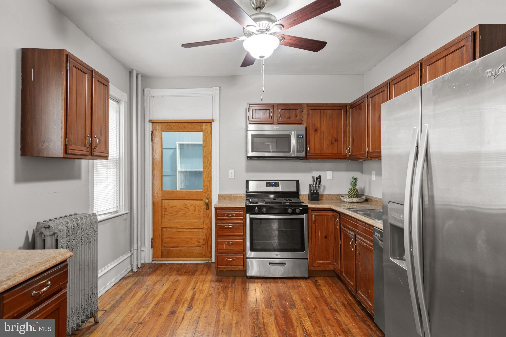 830 North Duke Street Lancaster, PA 17602 - Photo 13 of 41 a kitchen with stainless steel appliances a stove a refrigerator a sink a oven with wooden floor and cabinets
