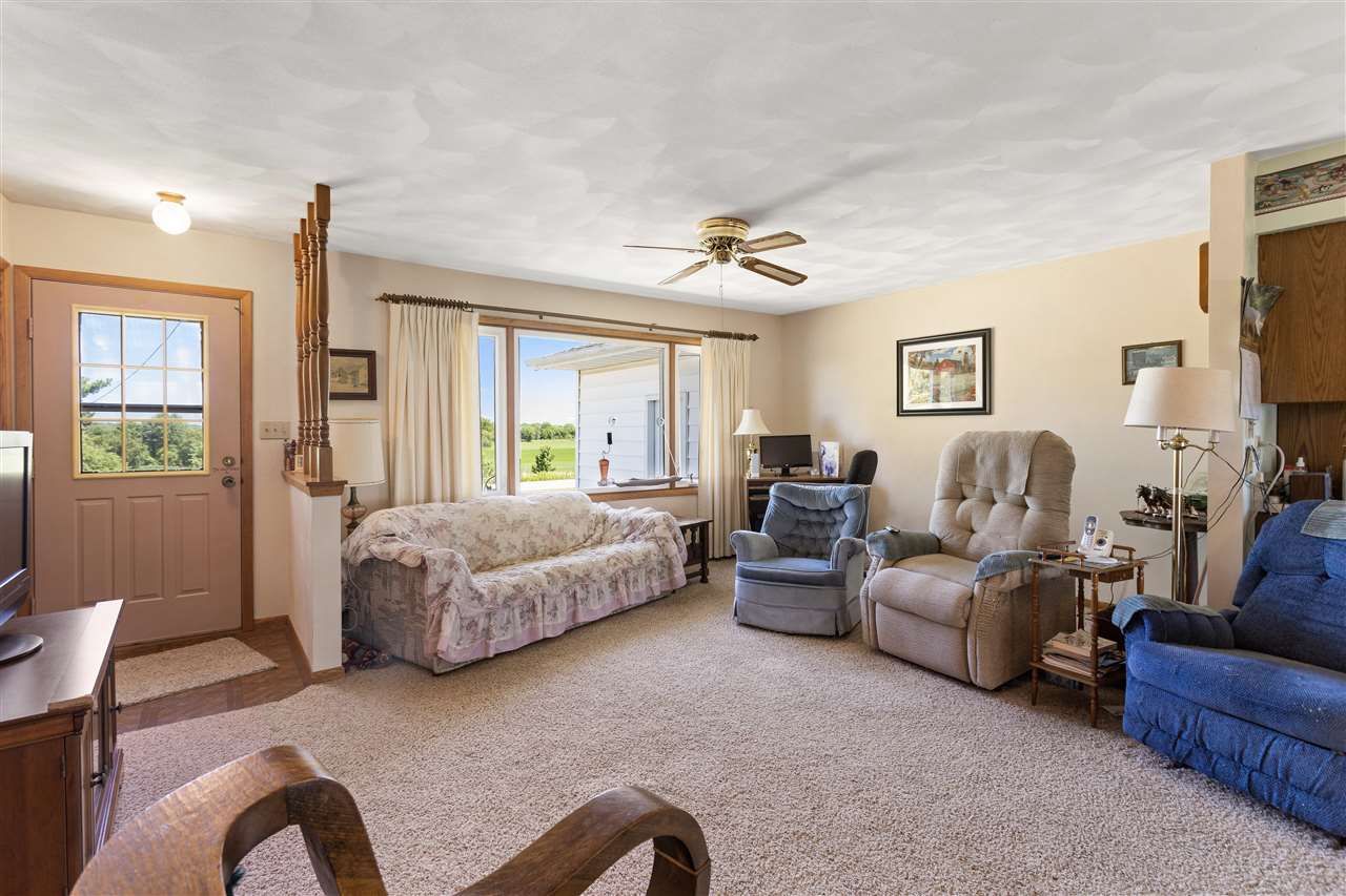 7365 East Ridott Road Ridott, IL 61067 - Photo 3 of 26 a spacious bedroom with a bed couch and a window