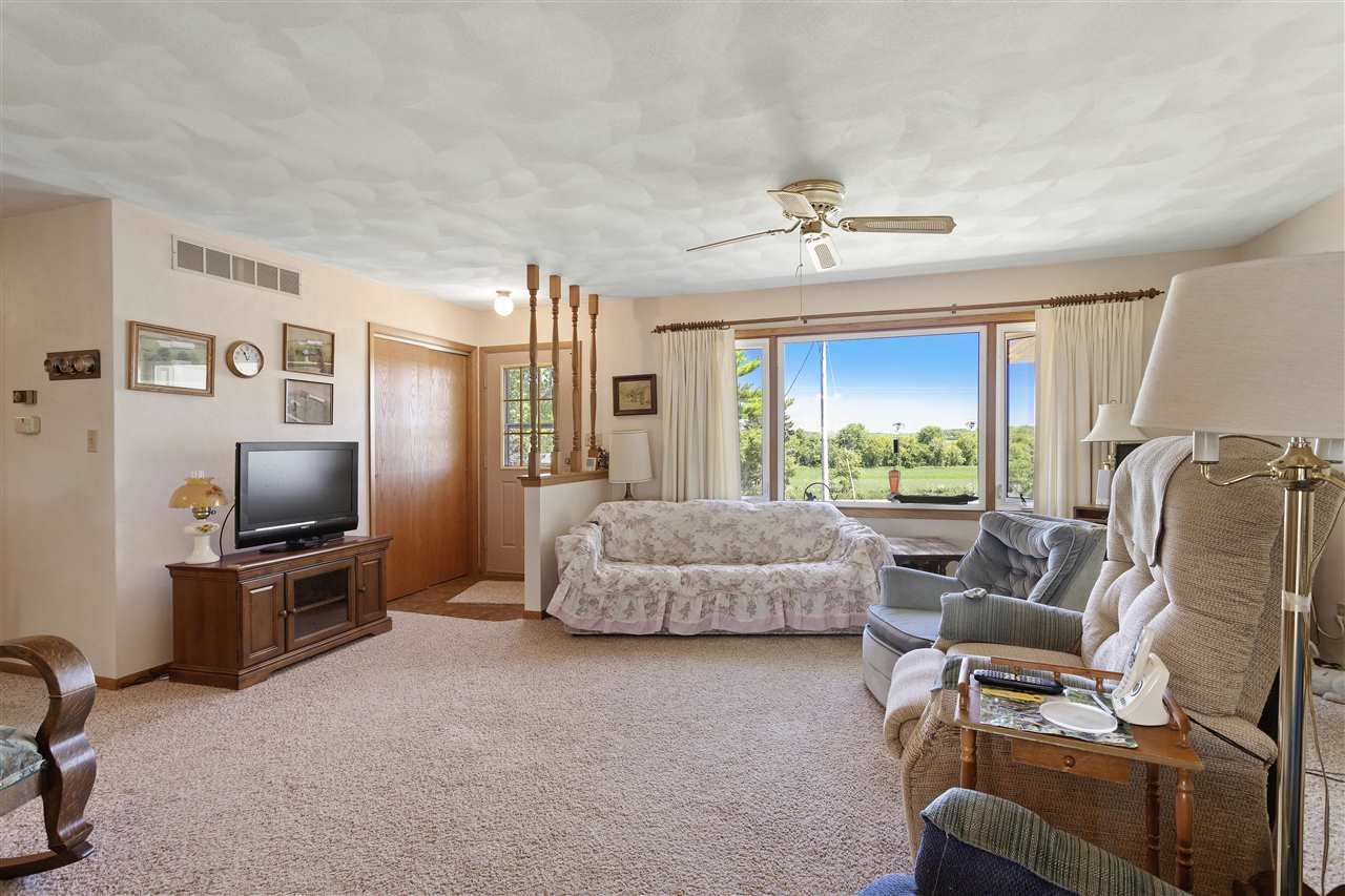 7365 East Ridott Road Ridott, IL 61067 - Photo 4 of 26 a living room with furniture and a flat screen tv