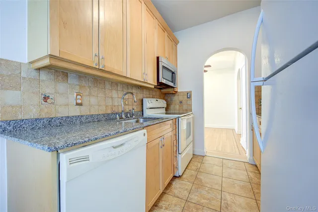 a kitchen with stainless steel appliances granite countertop a sink and cabinets