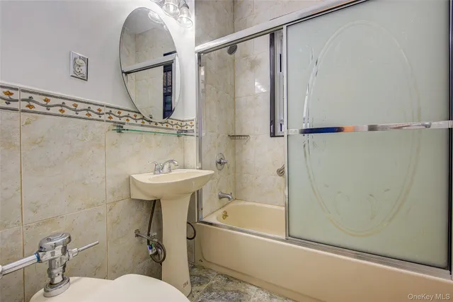 a bathroom with a sink mirror toilet and bathtub