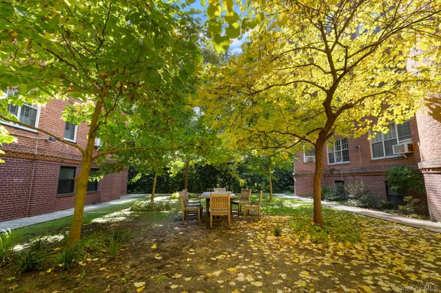 a white house that has a tree in front of it