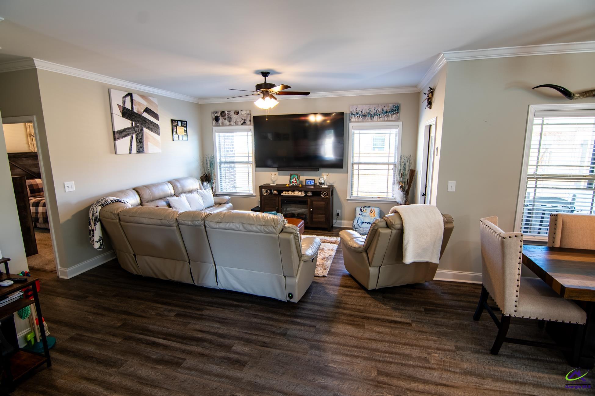 123 Logan's Mill Trail Warner Robins, GA 31093 - Photo 2 of 23 a living room with furniture a flat screen tv and a fireplace