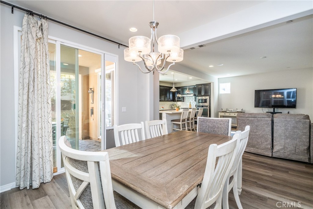 32390 Magee Lane Temecula, CA 92592 - Photo 22 of 75 a view of a dining room with furniture window and wooden floor