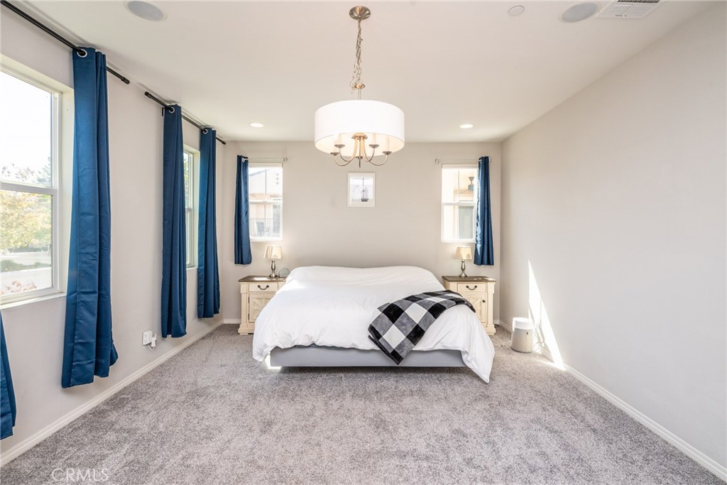 32390 Magee Lane Temecula, CA 92592 - Photo 33 of 75 a spacious bedroom with a bed mirror and window