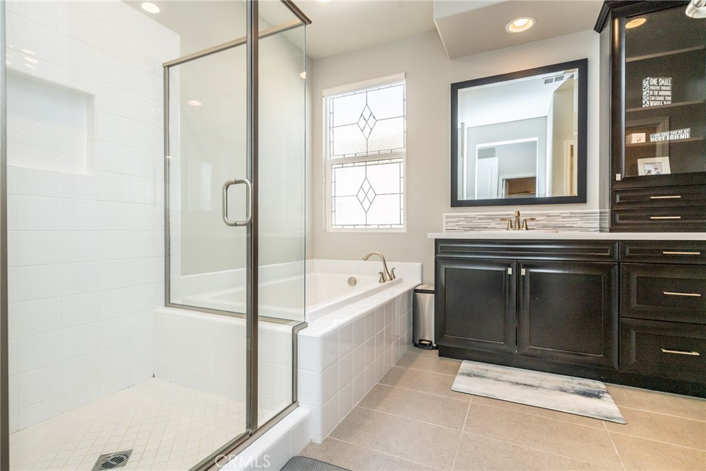 32390 Magee Lane Temecula, CA 92592 - Photo 38 of 75 a spacious bathroom with a tub sink shower and mirror