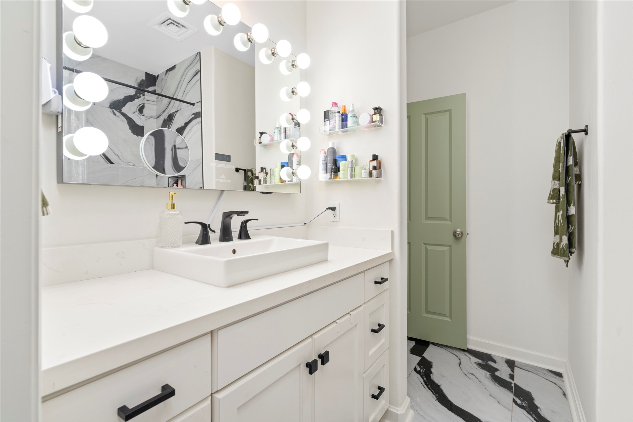 914 Main Street, Unit 1008 Houston, TX 77002 - Photo 18 of 26 Sleek quartz surfaces, a modern sink, and updated cabinetry elevate this truly exceptional primary bathroom.