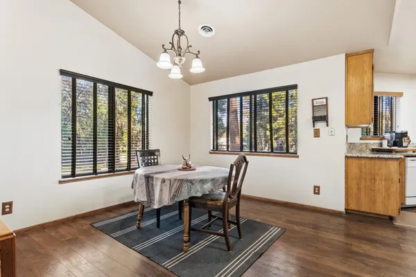 an empty room with window and ceiling fan