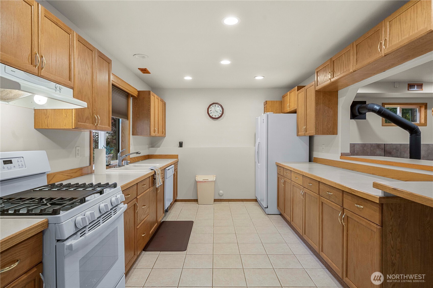 21103 16th Street East Lake Tapps, WA 98391 - Photo 19 of 30 a large kitchen with stainless steel appliances granite countertop a stove and a sink