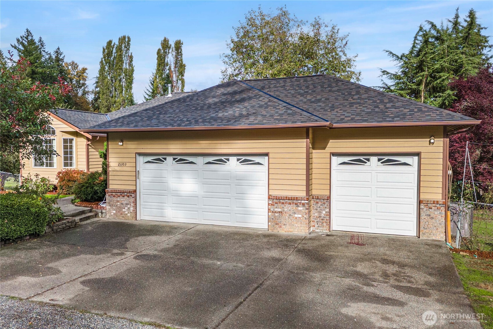 21103 16th Street East Lake Tapps, WA 98391 - Photo 2 of 30 a front view of a house with a yard and garage