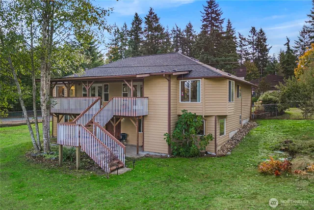a view of a house with a yard and tree s