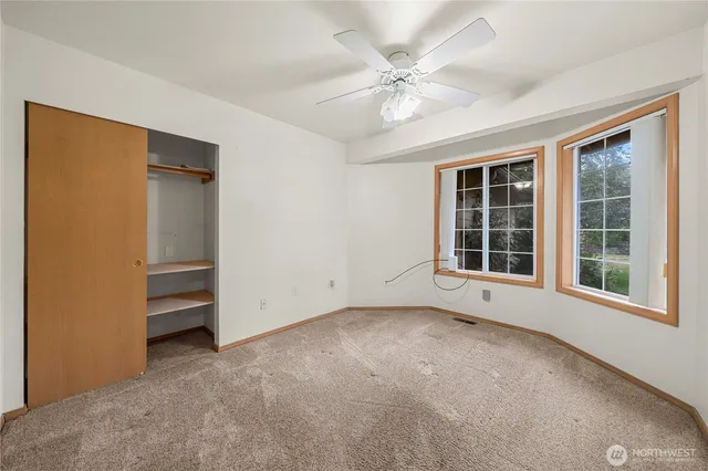 an empty room with a empty space and windows