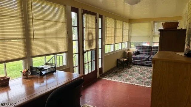a view of a room with kitchen island granite countertop a large window