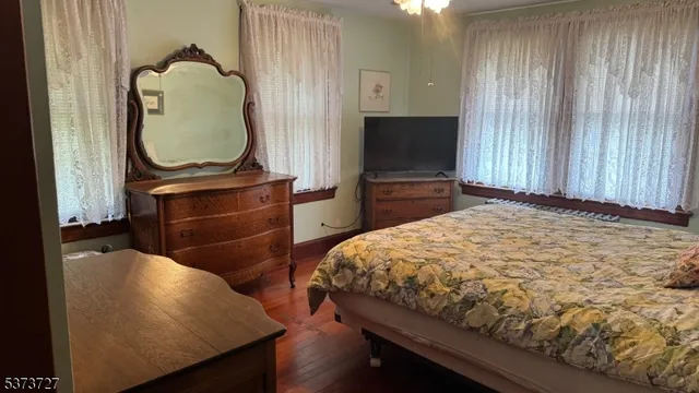 a bedroom with a bed and flat screen tv