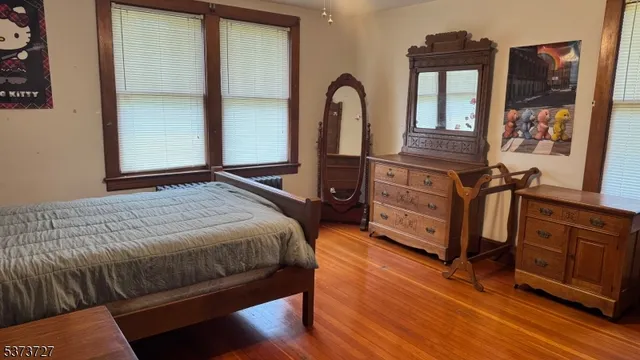a bedroom with a bed next to a window