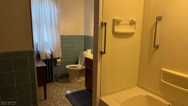 a bathroom with a toilet and a shower