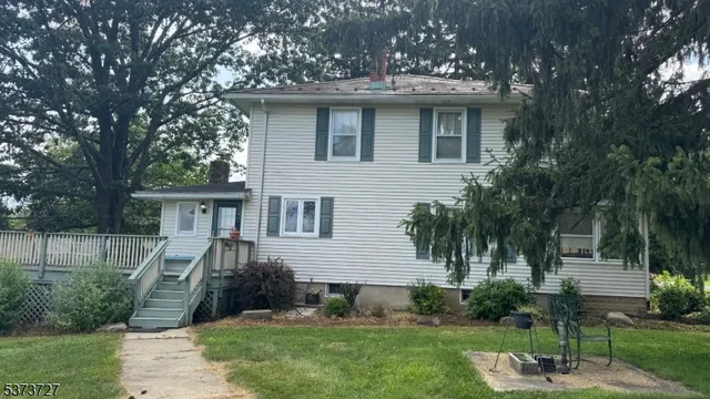 a front view of a house with a yard and potted plants