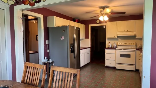 a kitchen with stainless steel appliances a refrigerator and a stove top oven