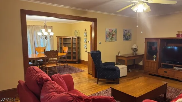 a living room with furniture a flat screen tv and large window