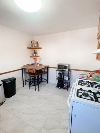 a living room with furniture and a dining table