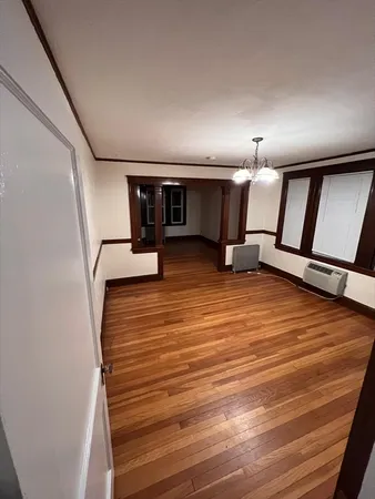 a view of a room with wooden floor