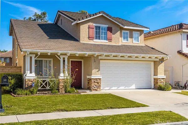 a front view of a house with a yard
