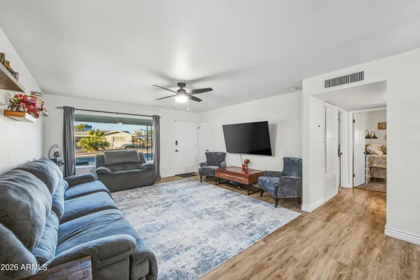 a spacious bedroom with a bed and a cabinets