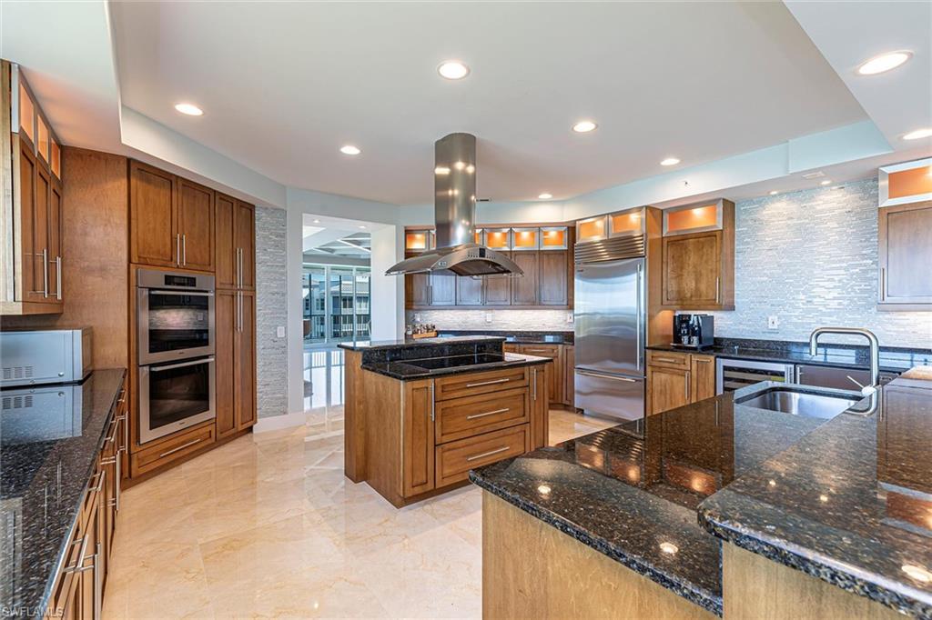 295 Grande Way, Unit PH2 Naples, FL 34110 - Photo 6 of 45 a kitchen with stainless steel appliances granite countertop a stove a sink and a refrigerator