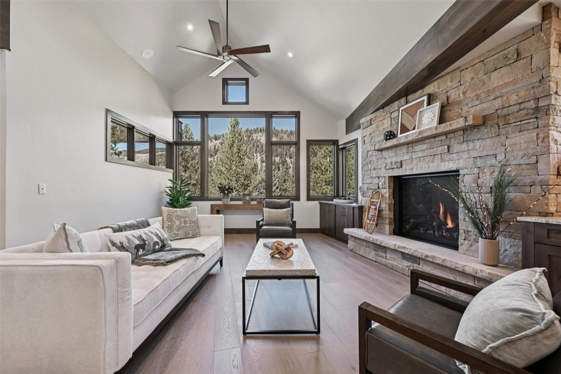 27 West Independence Road Keystone, CO 80435 - Photo 11 of 48 Living area featuring wood finished floors, high vaulted ceiling, a fireplace, ceiling fan, and recessed lighting