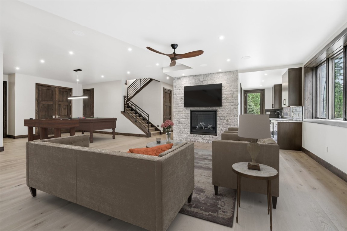27 West Independence Road Keystone, CO 80435 - Photo 27 of 48 Living area featuring a fireplace, light wood-style flooring, a ceiling fan, recessed lighting, and pool table