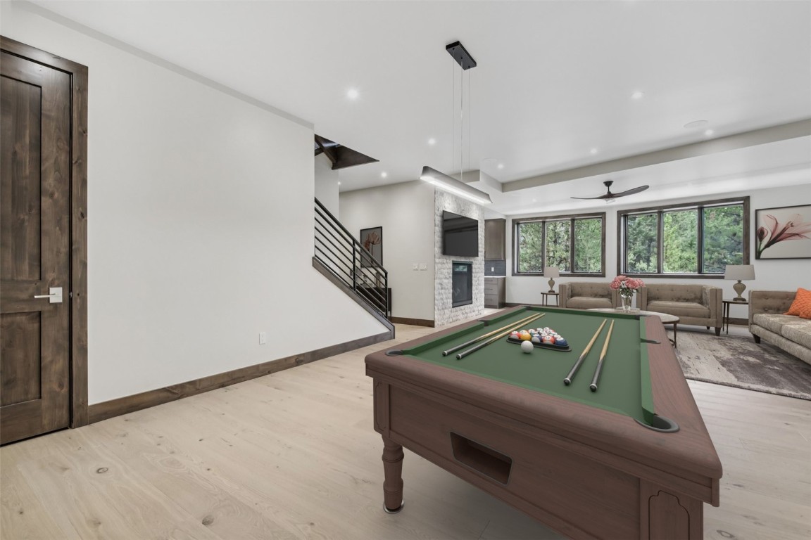 27 West Independence Road Keystone, CO 80435 - Photo 28 of 48 Virtually Staged Game room featuring light wood-type flooring, billiards table, ceiling fan, recessed lighting, and a stone fireplace