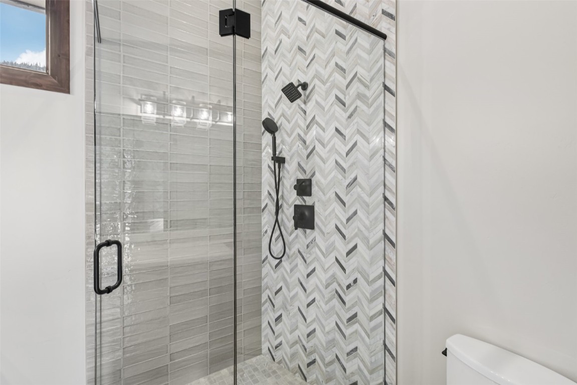 27 West Independence Road Keystone, CO 80435 - Photo 43 of 48 Full bath featuring a shower stall and toilet