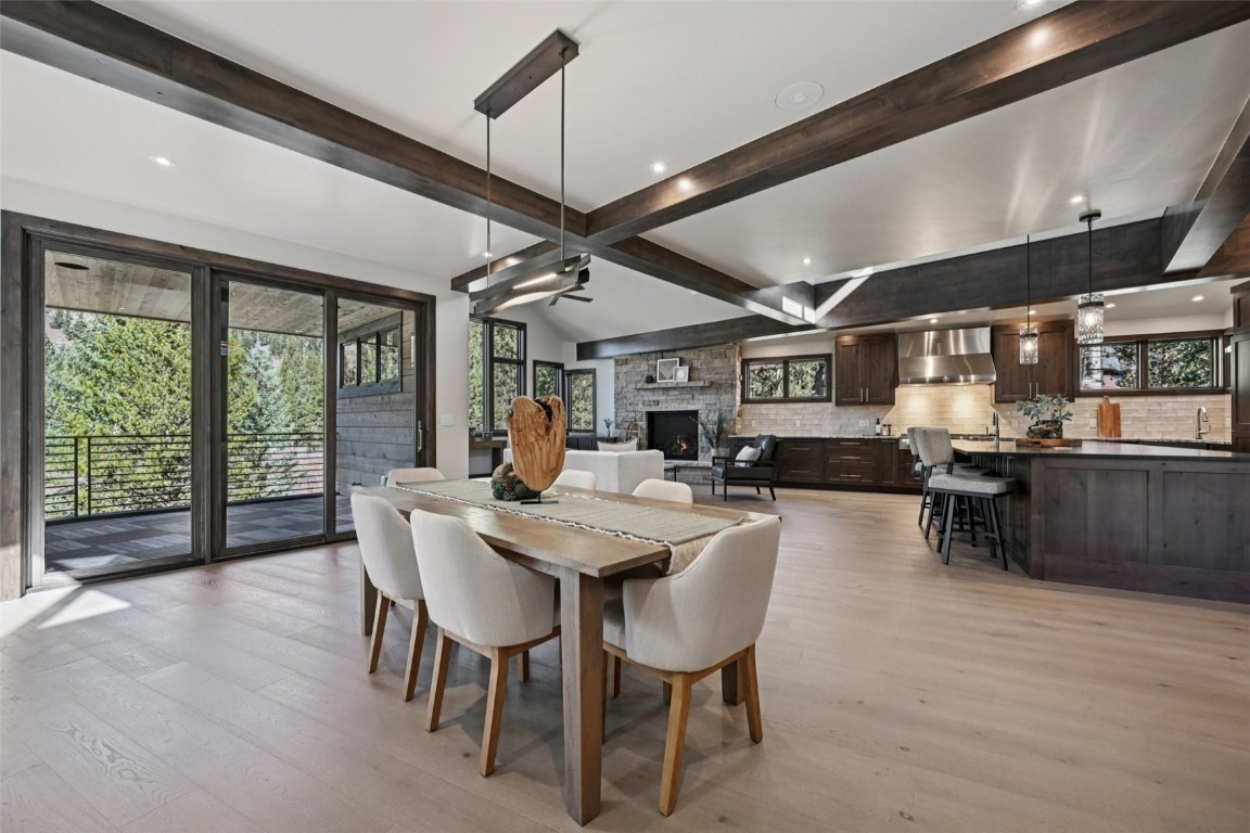 27 West Independence Road Keystone, CO 80435 - Photo 5 of 48 Dining space with beamed ceiling, light wood-style flooring, a fireplace, and recessed lighting
