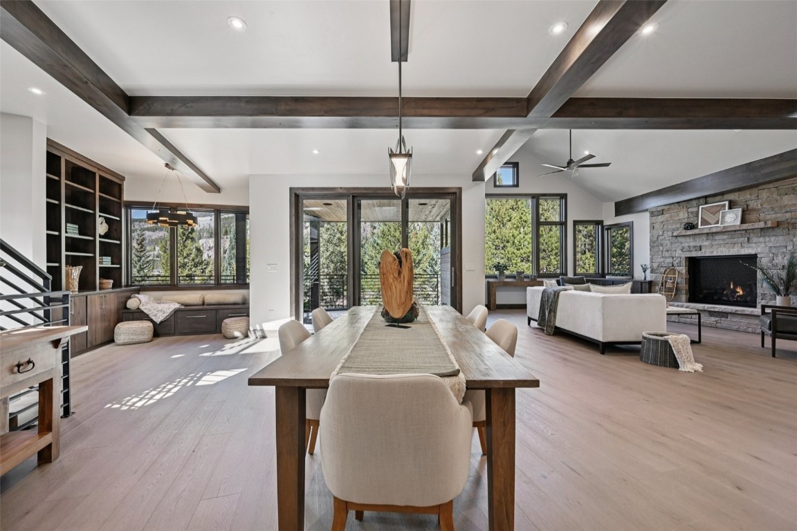 27 West Independence Road Keystone, CO 80435 - Photo 7 of 48 Dining area with wood finished floors, healthy amount of natural light, a stone fireplace, recessed lighting, and ceiling fan