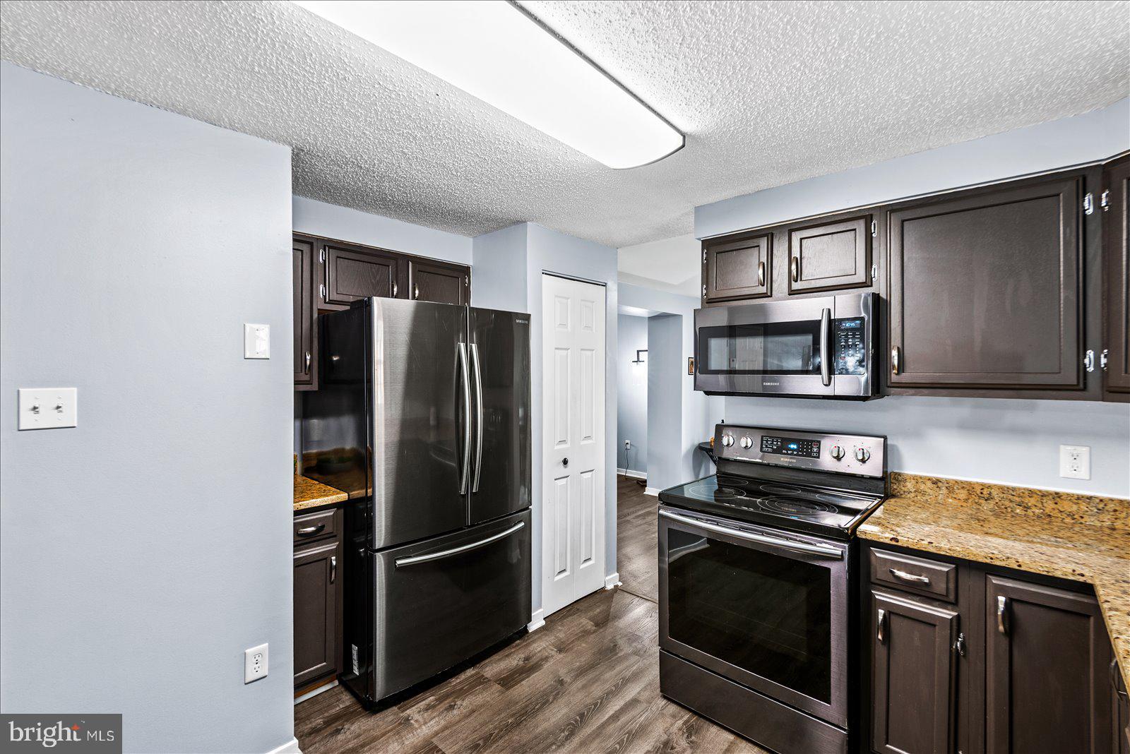 218 Victoria Drive Ruther Glen, VA 22546 - Photo 18 of 73 a kitchen with stainless steel appliances a refrigerator stove and microwave