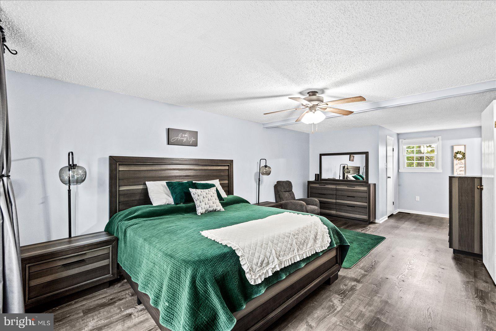 218 Victoria Drive Ruther Glen, VA 22546 - Photo 27 of 73 a bedroom with a large bed and a chandelier