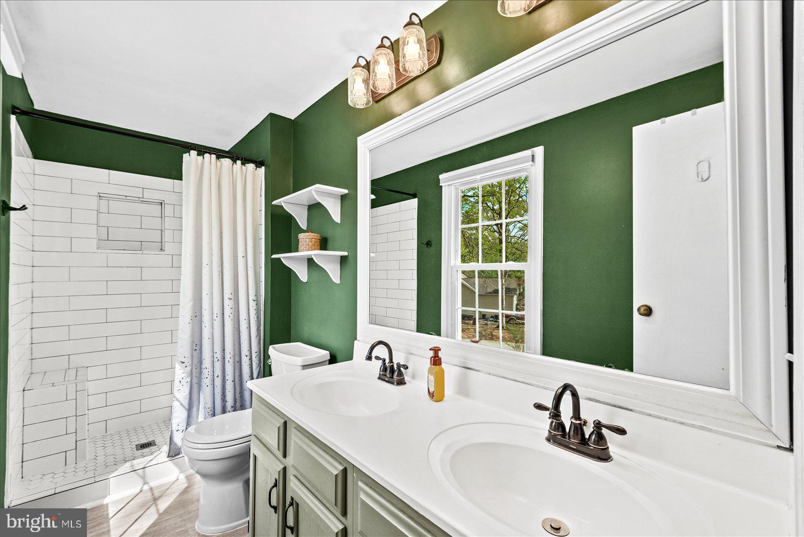 218 Victoria Drive Ruther Glen, VA 22546 - Photo 30 of 73 a bathroom with a sink a toilet and shower