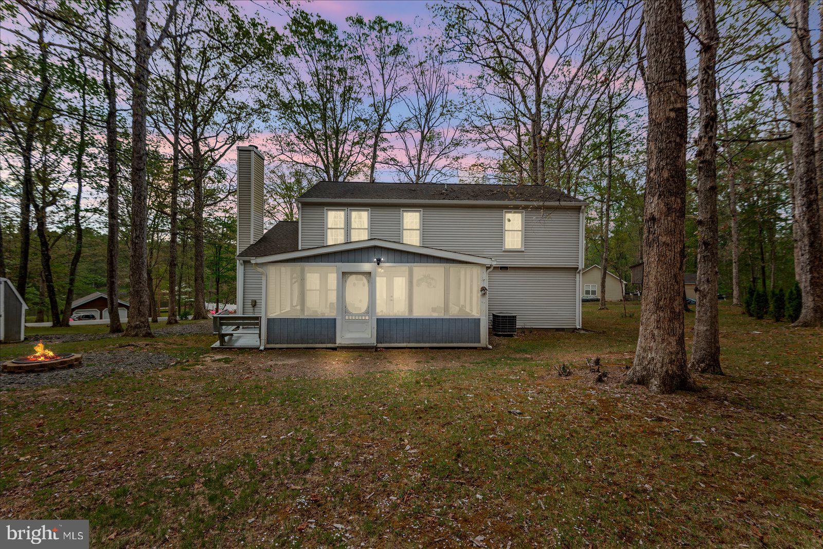 218 Victoria Drive Ruther Glen, VA 22546 - Photo 40 of 73 a view of a house with a large tree and a big yard