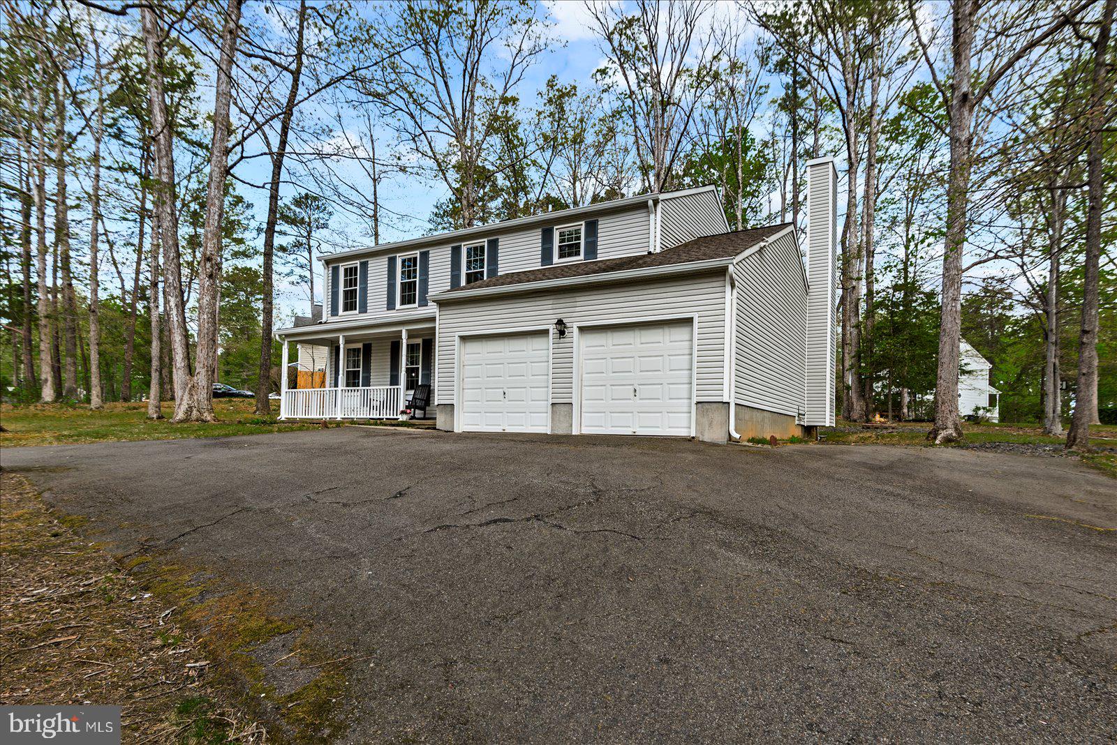 218 Victoria Drive Ruther Glen, VA 22546 - Photo 4 of 73 front view of a house with a road